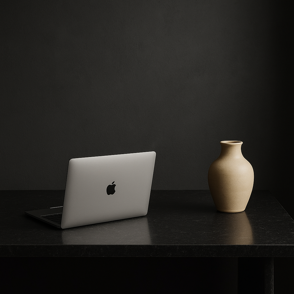 Minimalist desk scene with a laptop and a vase