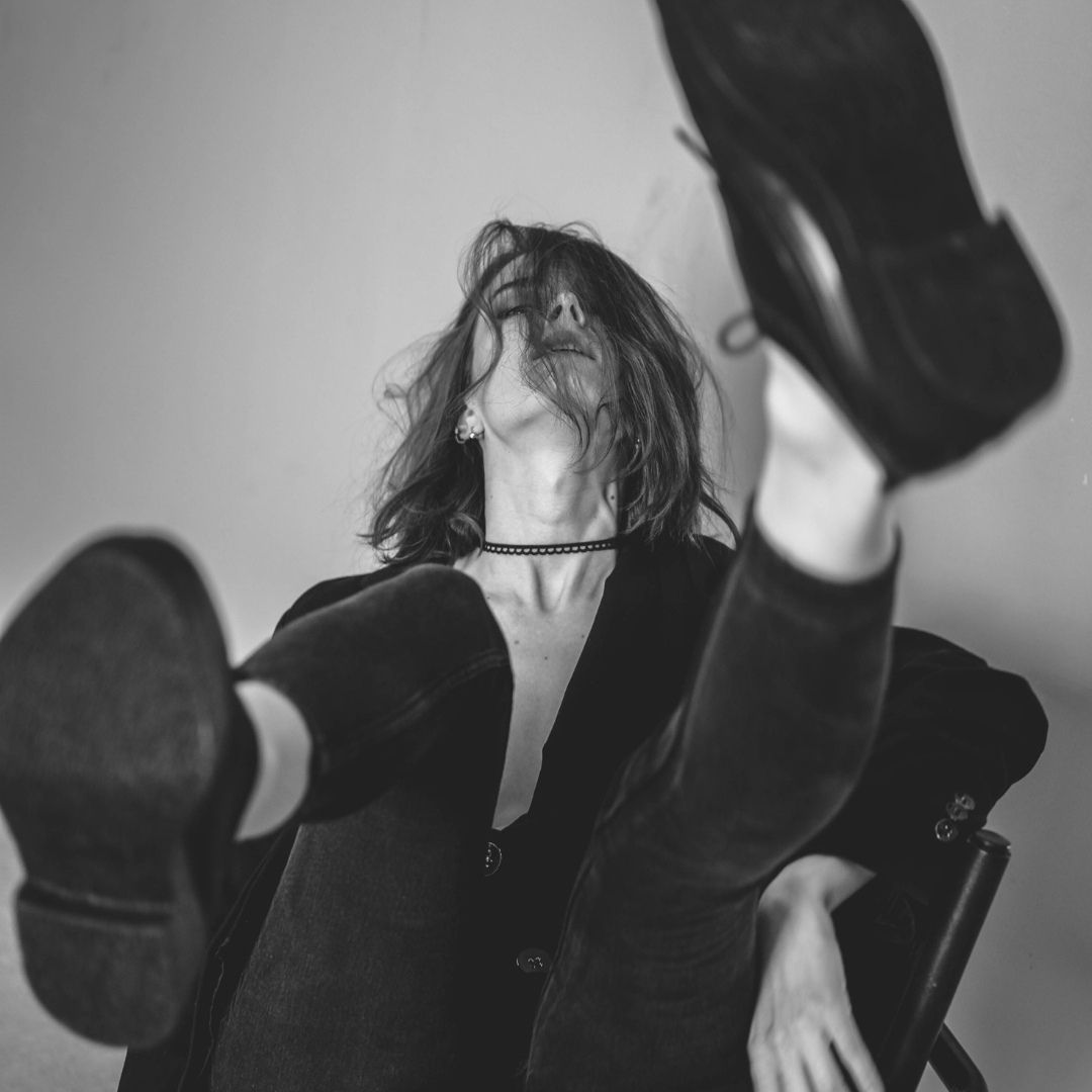 Black and white photo of a model in a black outfit